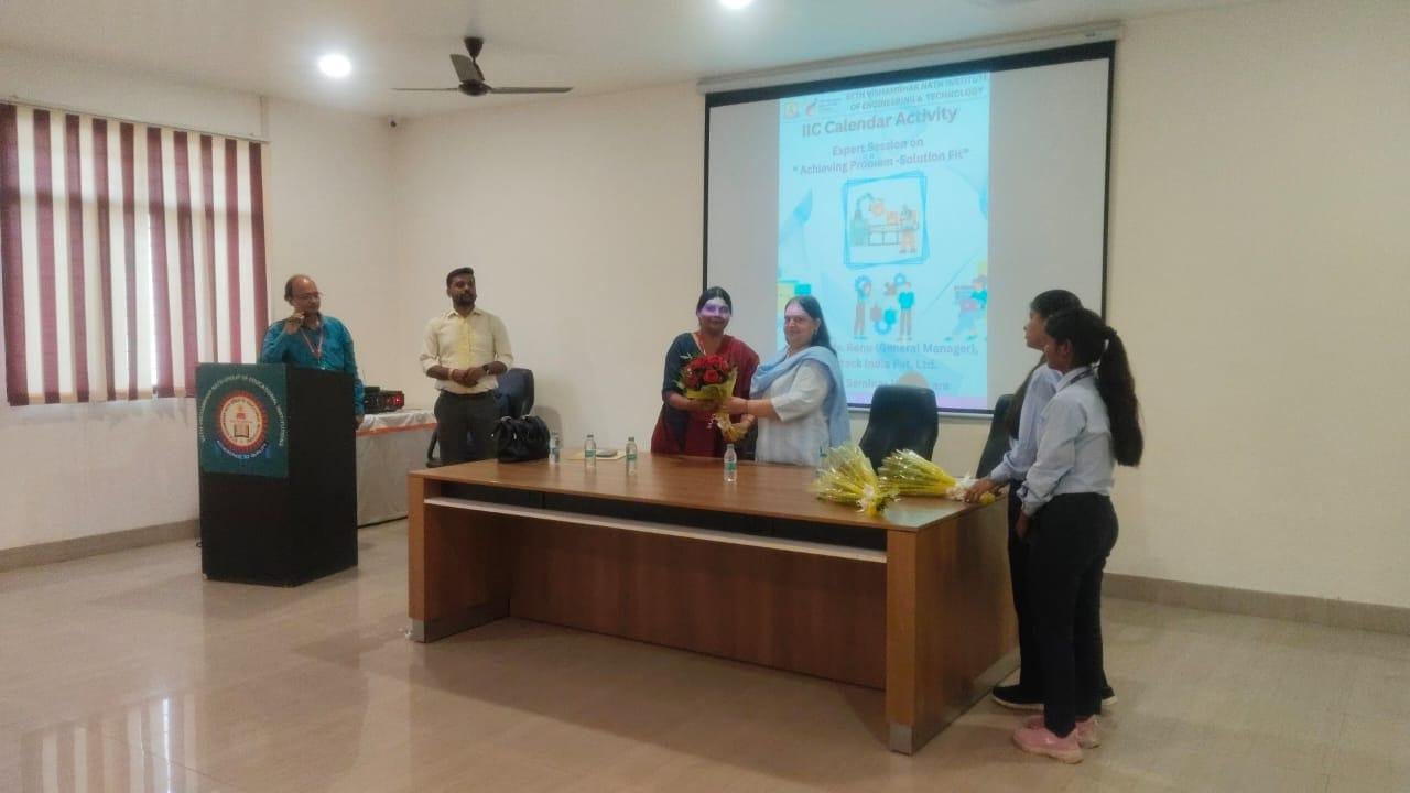 Guest felicitation on stage at a campus seminar