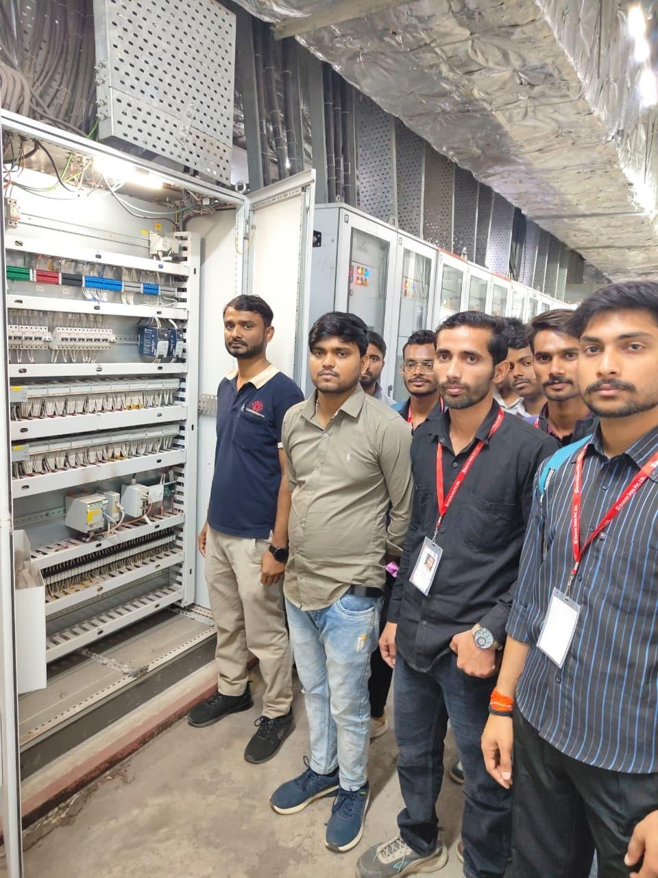 Students inspecting a live industrial control panel